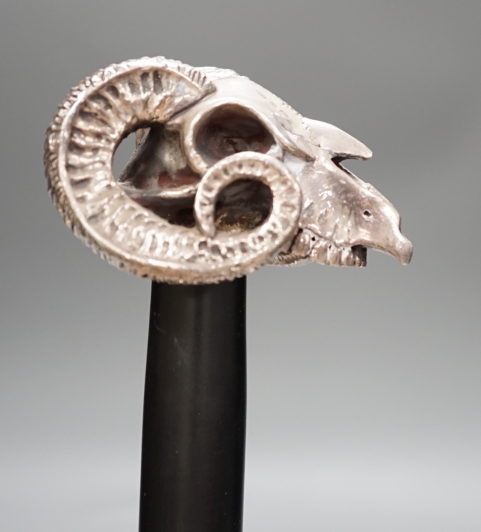 A Jeffery West umbrella with modern filled silver ram skull handle